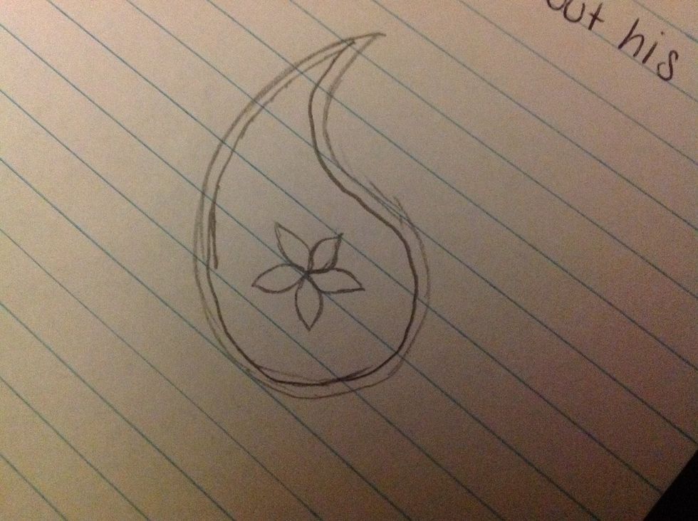 Then, draw a simple design in the middle of the shape. I like drawing flowers in mine.