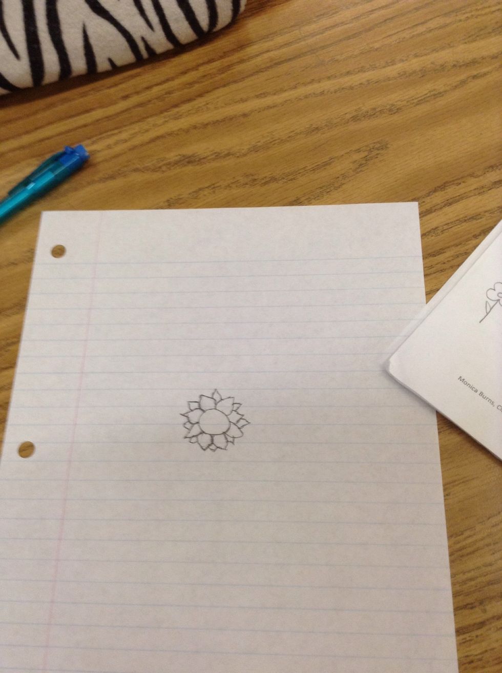 Then draw smaller petal shapes in between the spaces of the other petal shapes.repeat until the spaces are filled.