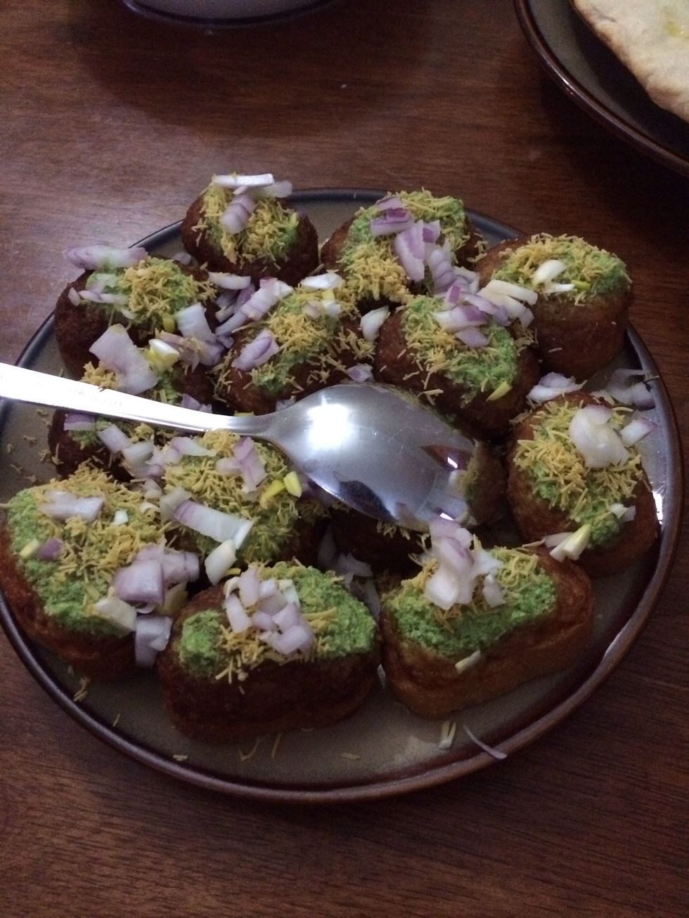 Then dress them up. I covered them with a layer of capsicum and chilli chutney, then a layer of sev Indian snack & chopped onions. Enjoy!