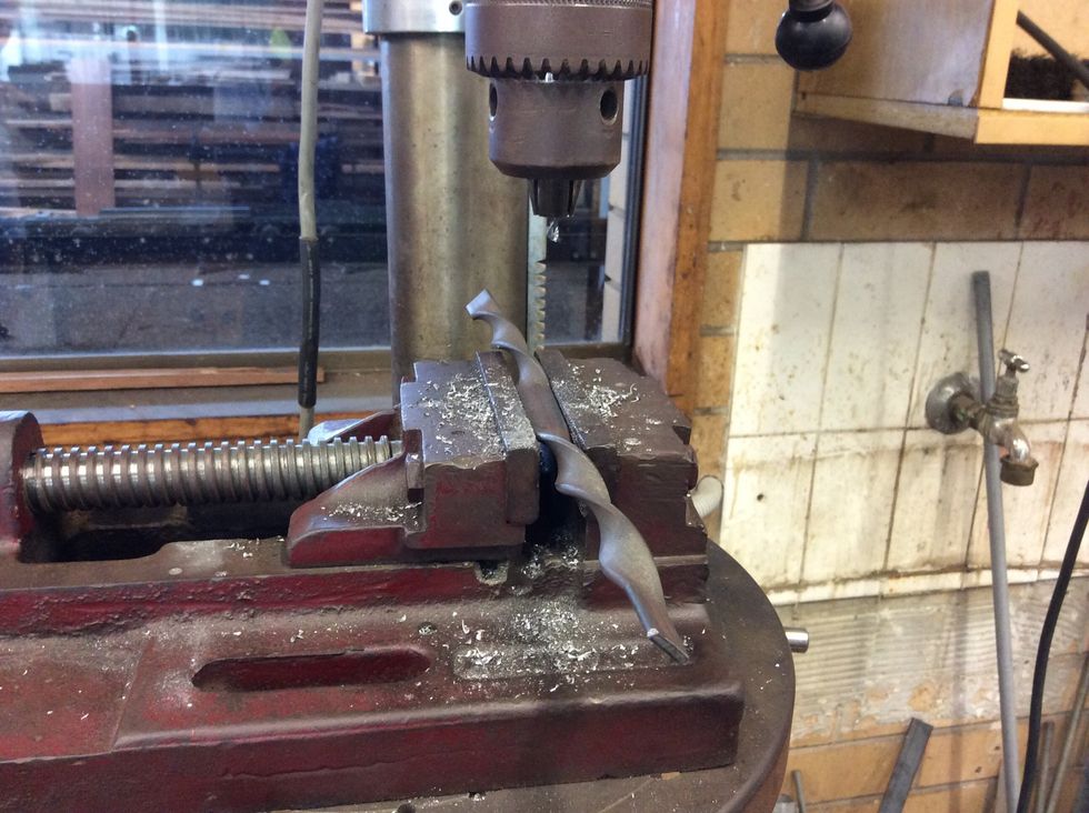 Then drill a hole in the twisted piece of metal.