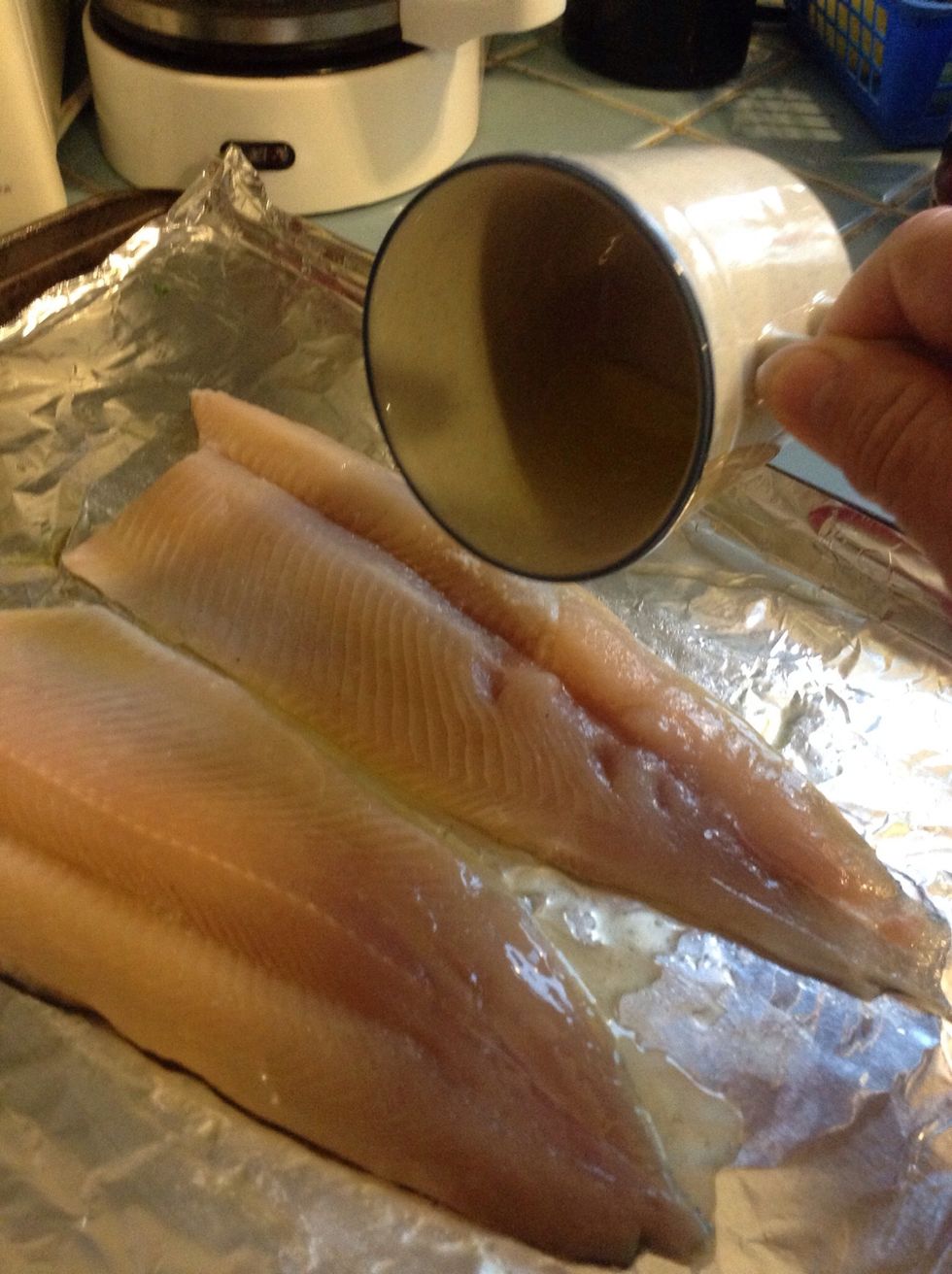 Then drizzle the butter over your fish as well. Rub it in on both sides with your fingers