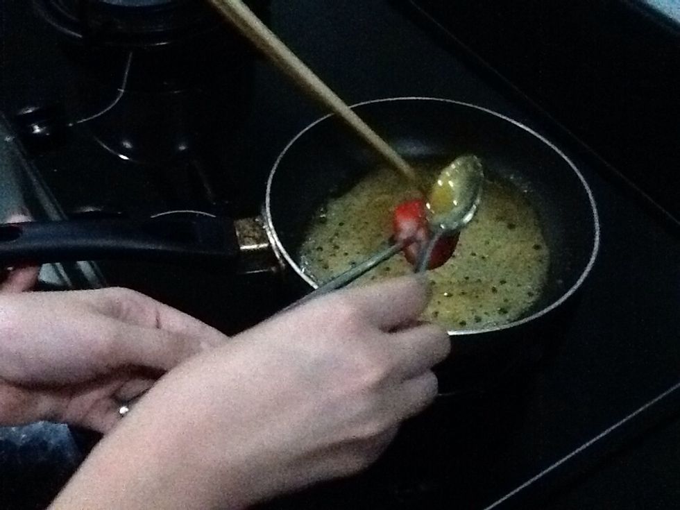 Then dunk the strawberry into the sugar to coat it