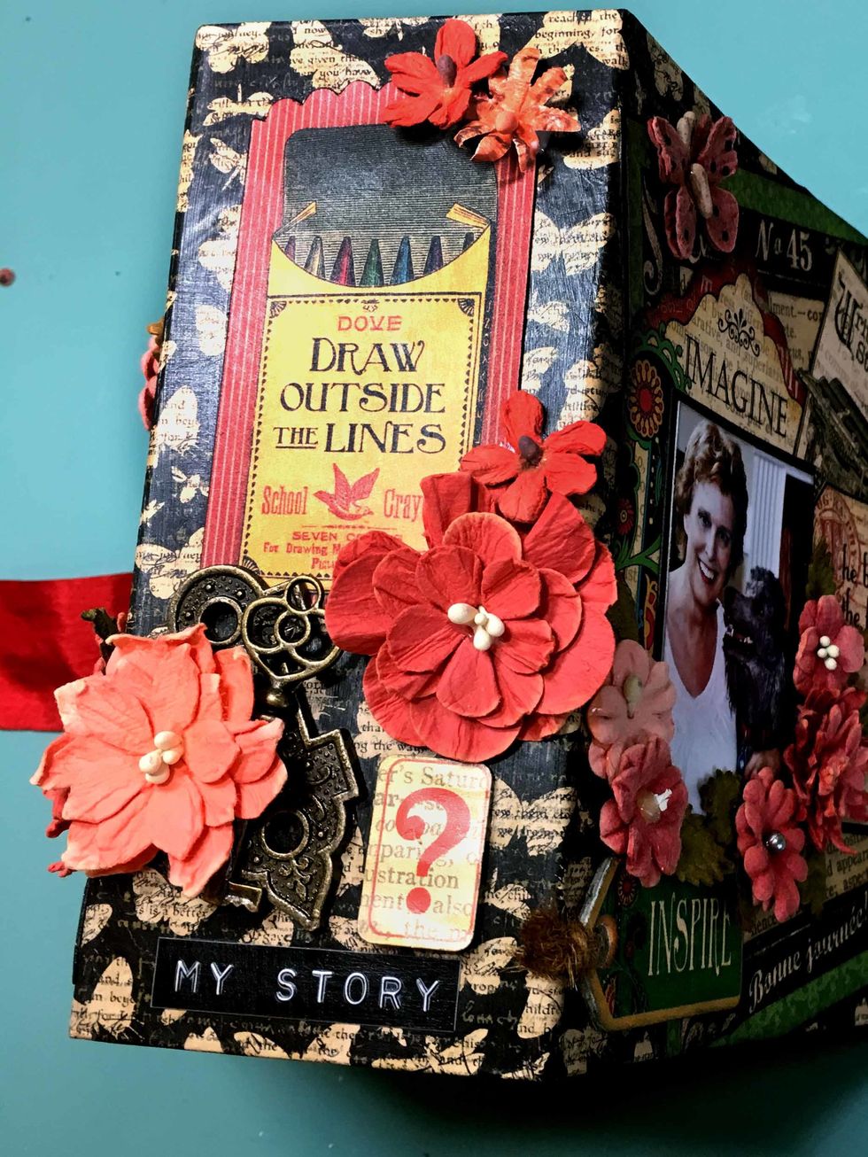 Then embellish as you please. I use a tag from the Tags and Pockets and a question mark sticker. I also glued a Staples key to a Staples key hole & then embellished with Petaloo flowers.