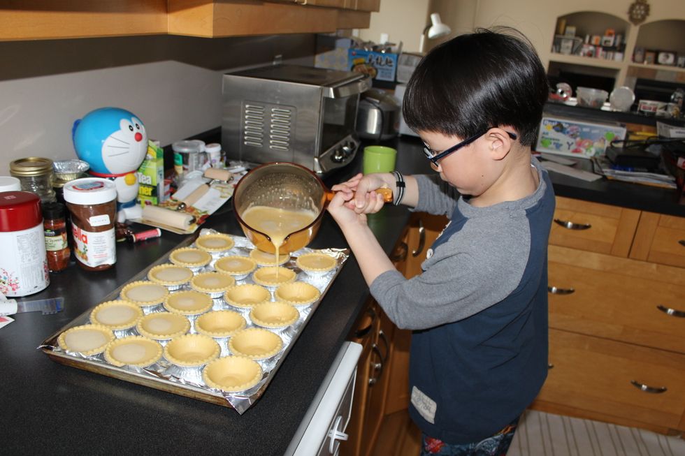 Then, fill the egg tarts with the filling