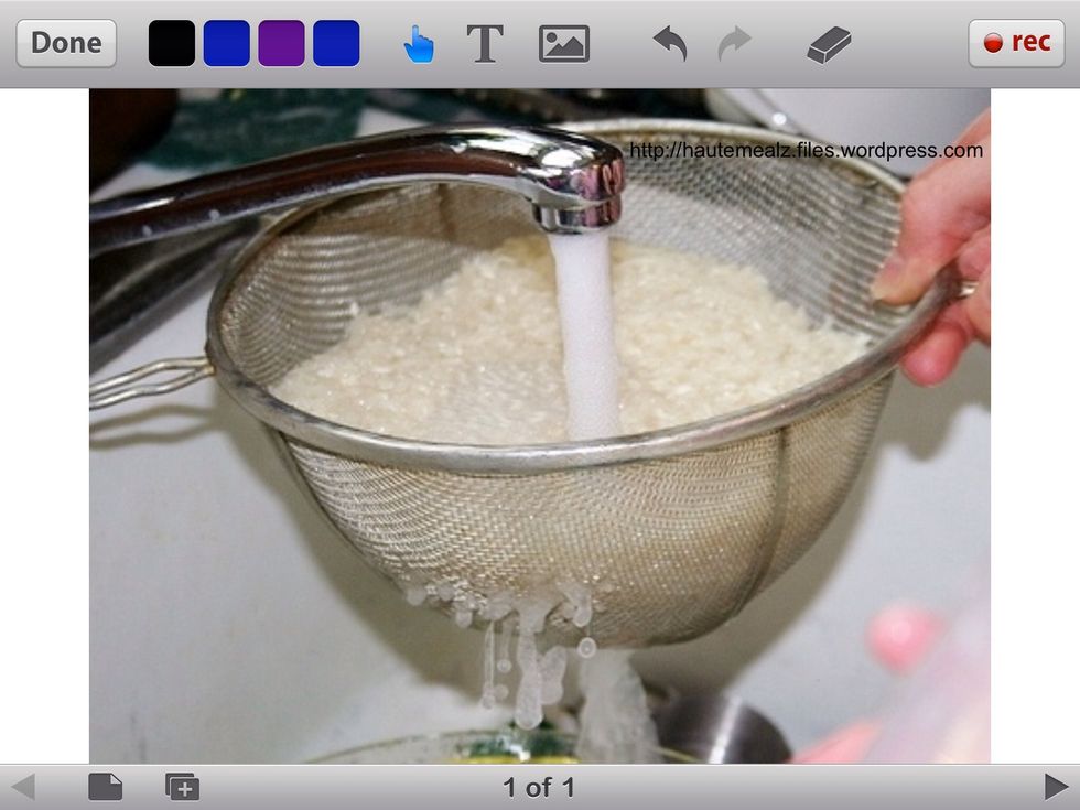 Then, fill the strainer containing uncooked rice with warm water. Let the water strain out again.
