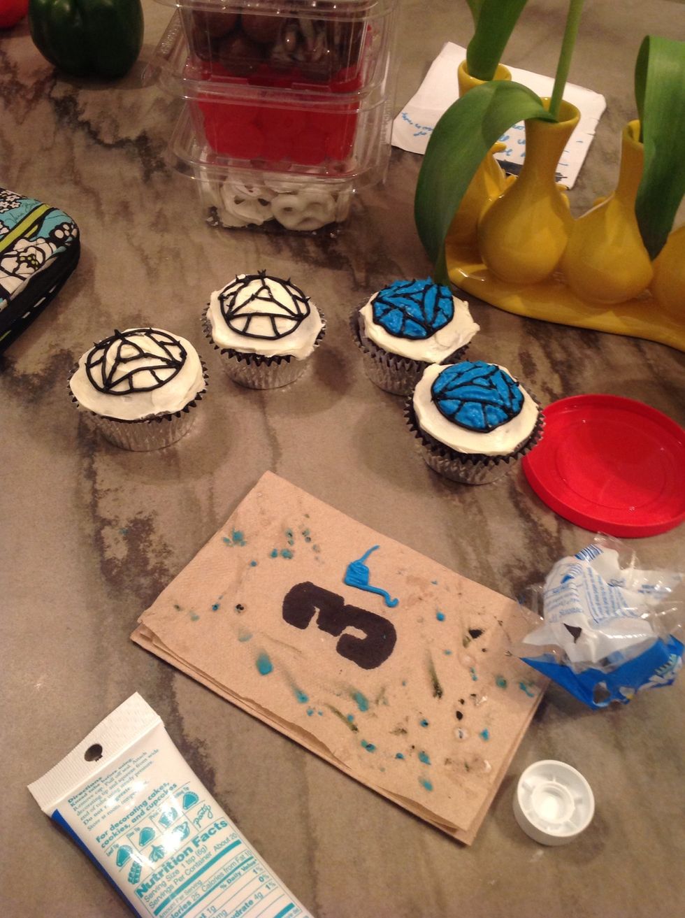 Then, fill them in with a light blue frosting, most likely out of a tube.