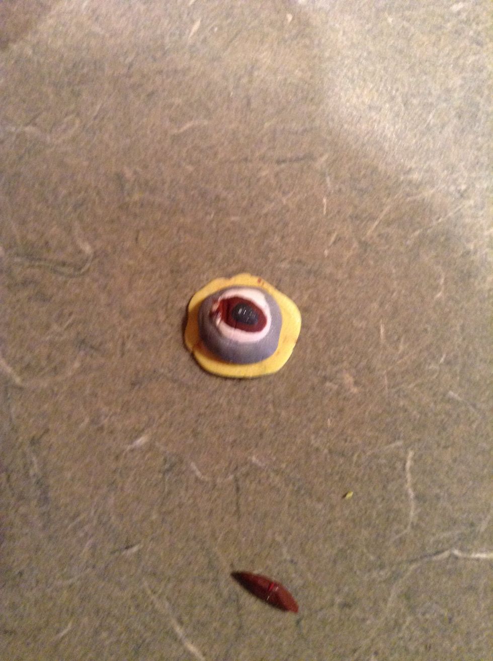 Then flatten out some yellow and put the eye on top of it.