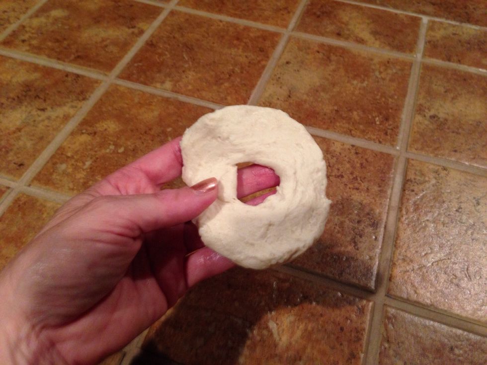 Then flatten the dough to form a thin donut.