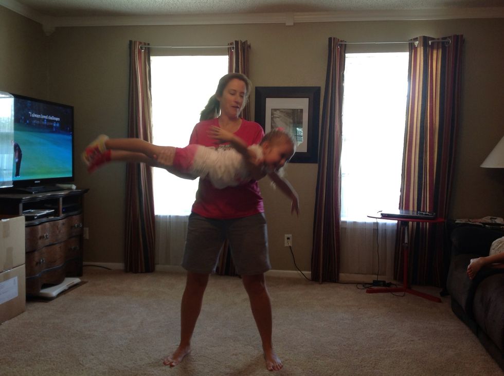 Then flip the child over and let her fly. Keep your arms tucked close to your sides and rotate the child around in a twisting fashion.