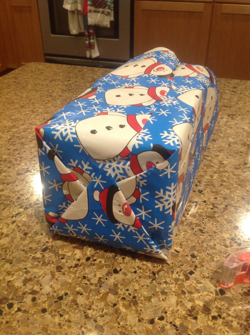 Then, flip the triangle flap up and tape it down like so.