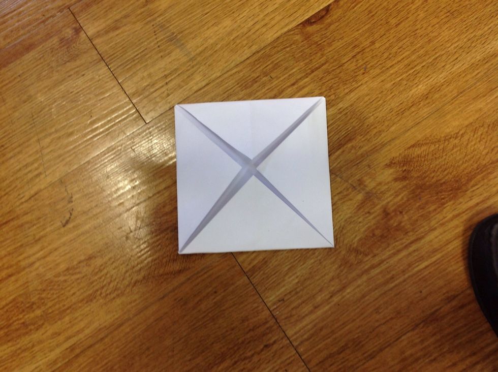 Then,fold 4 corners in the middle of the paper.