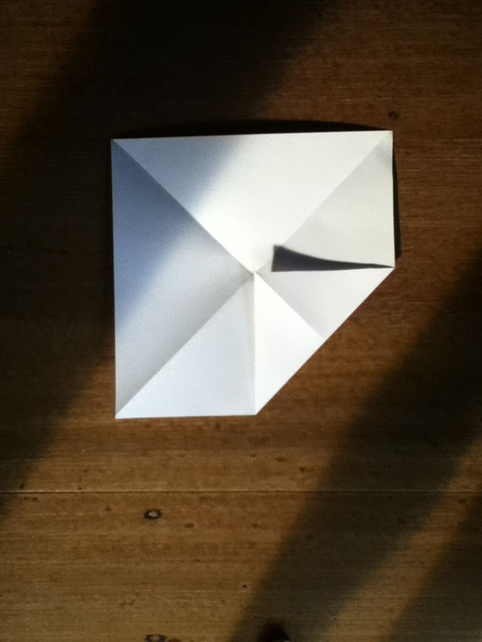 Then fold a corner of your paper into the middle