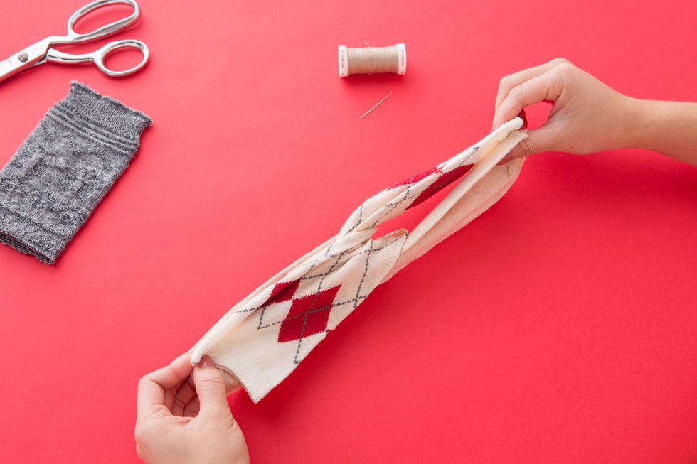 Then, fold each sock in half so that they crossover each other and the top and toe meet.