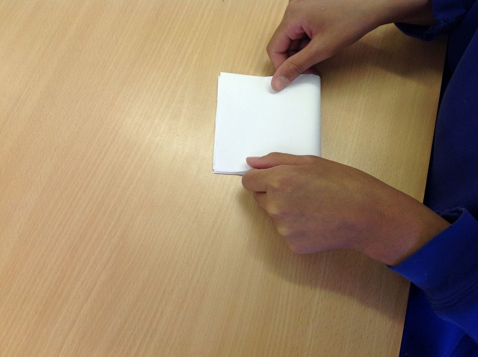 Then fold it again into the shape of a square.
