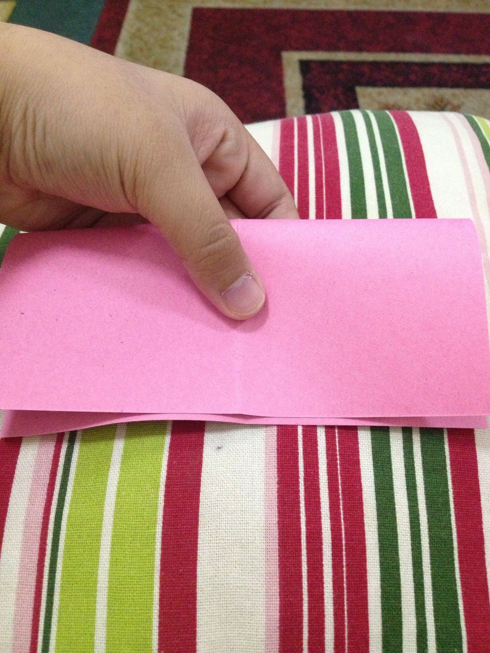 Then, fold it in half downward and unfold.