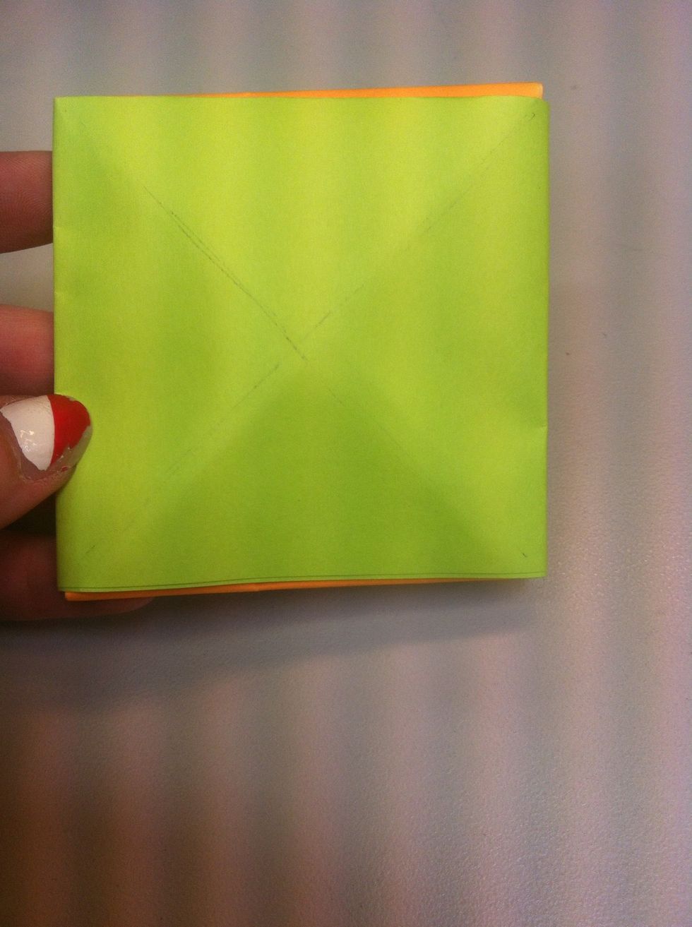 Then fold it other way so now you have a cross. The cross created a subtle tip that will cause our new spinner to spin.