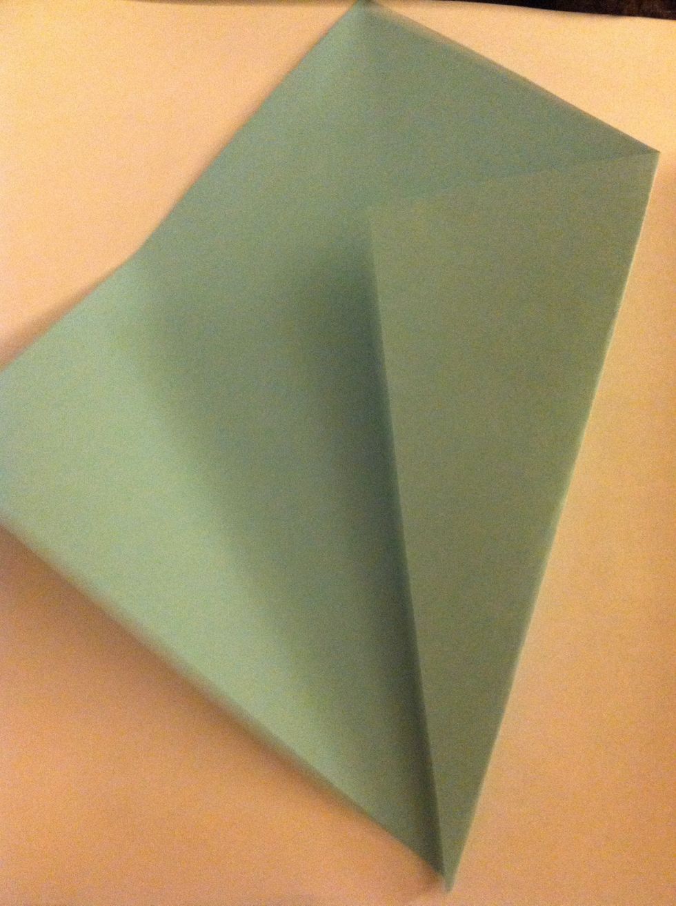 Then, fold one side so it lines up with the crease.
