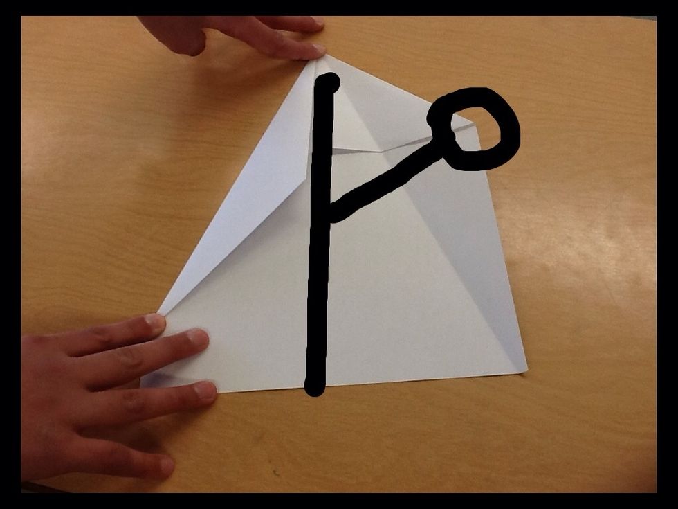 Then fold the circled corner to the middle of paper. Then do the same thing on the other side.