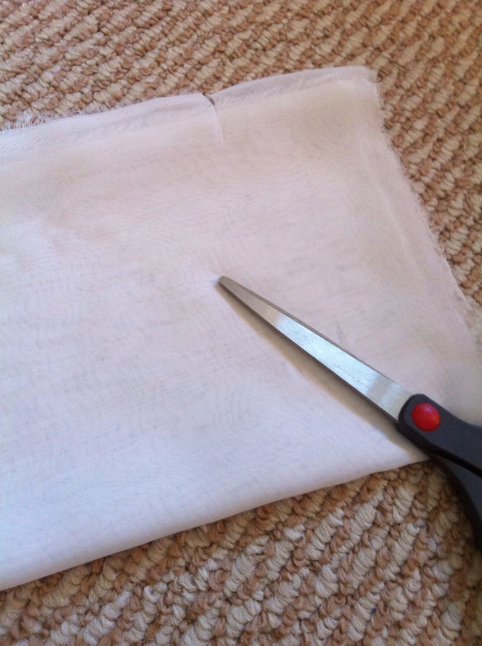 Then fold the fabric on the longer direction like this, and cut the excess out. Then, measure the length by rounding the fabric on ur waist, and cut the to length u like.