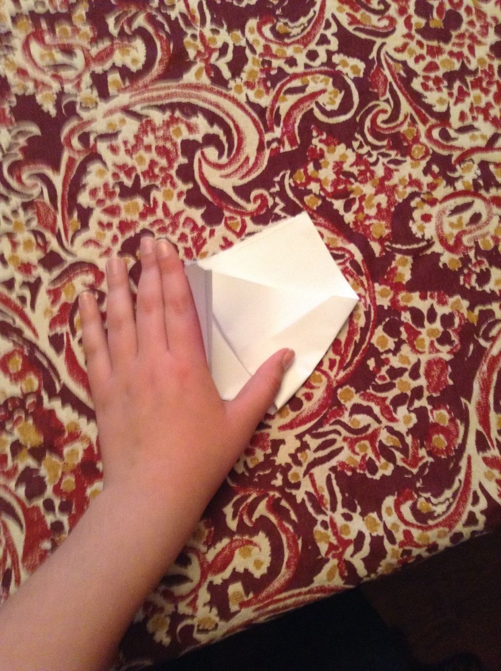 Then fold the left over the right piece following the past step like shown.