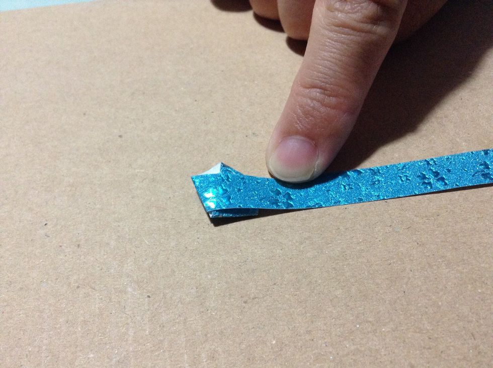 Then fold the long part of the paper along one side of the pentagon.