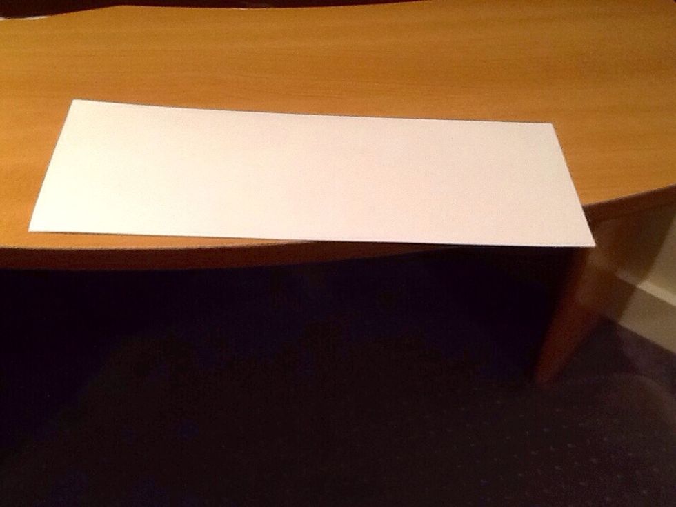 Then fold the paper in half.