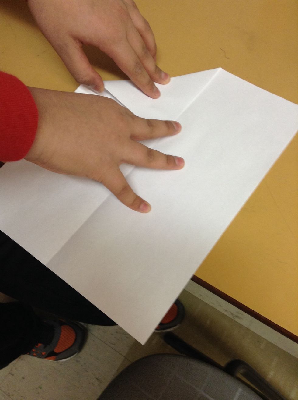 Then fold the top 2 corners so that they line up with the centre cris