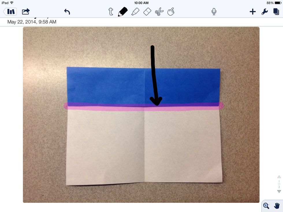 Then, fold the top of the paper to the horizontal crease.