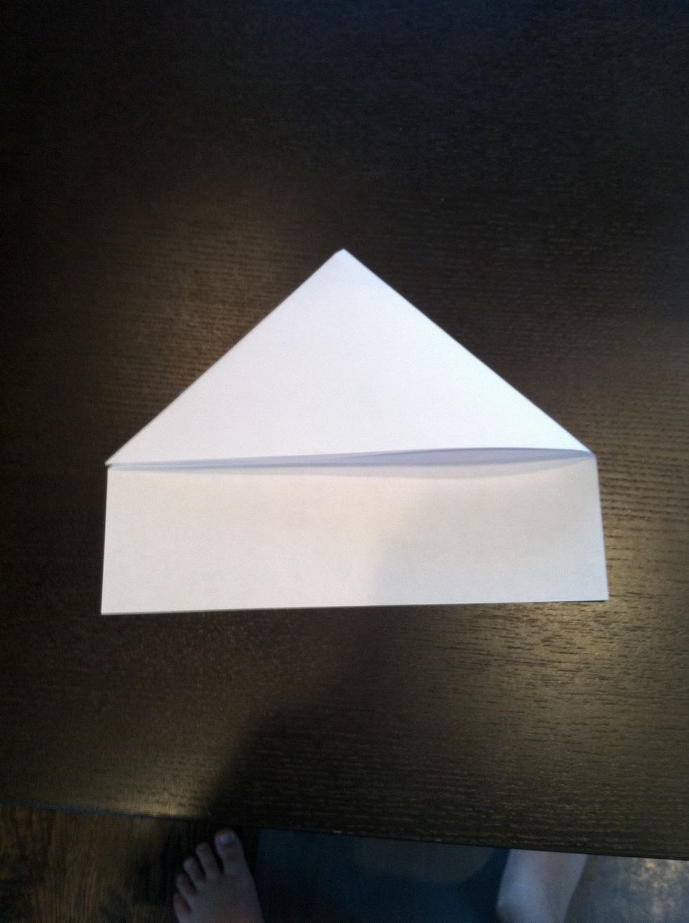 Then fold the top right corner to the bottom left corner of the triangle. If you want you can tape this part down.