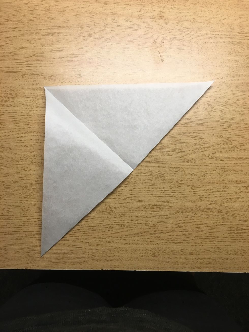 Then fold the triangle into a ... smaller triangle I guess. This can be done in a lot of ways and the more you fold the more detailed your snowflake will be.