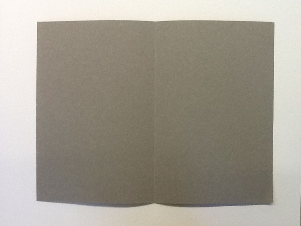 Then, fold your thick paper in half length-wise.