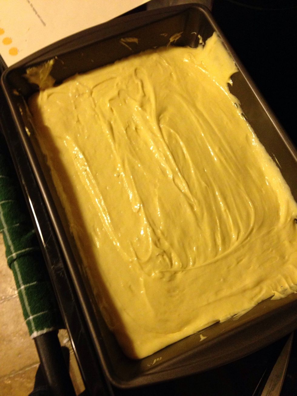 Then from the bowl pour the cake mix into the pan. And evenly spread around.