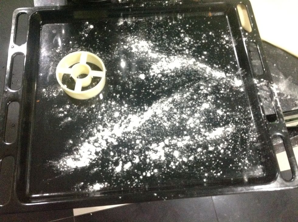 Then get a baking sheet and flour it as well. Also get your doughnut cutter.