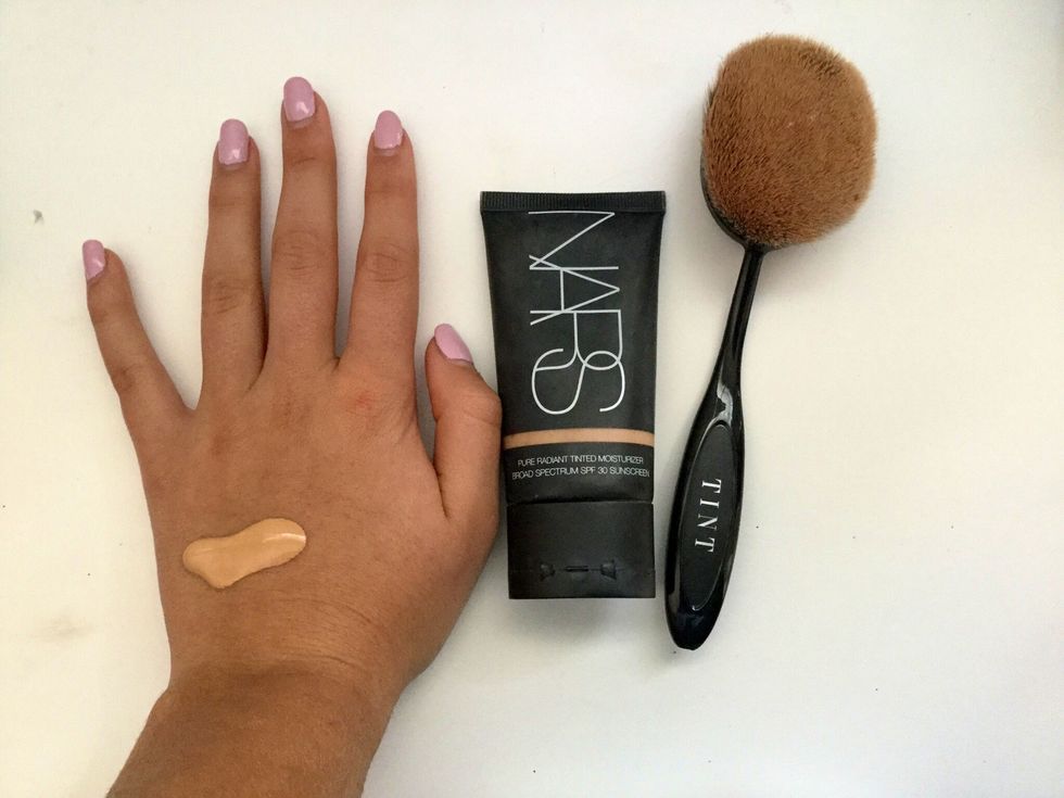 Then get out your foundation and foundation brush. Open the foundation and put a quarter size amount on the back of your hand and apply where skin is unevenly toned. Then blend into skin.