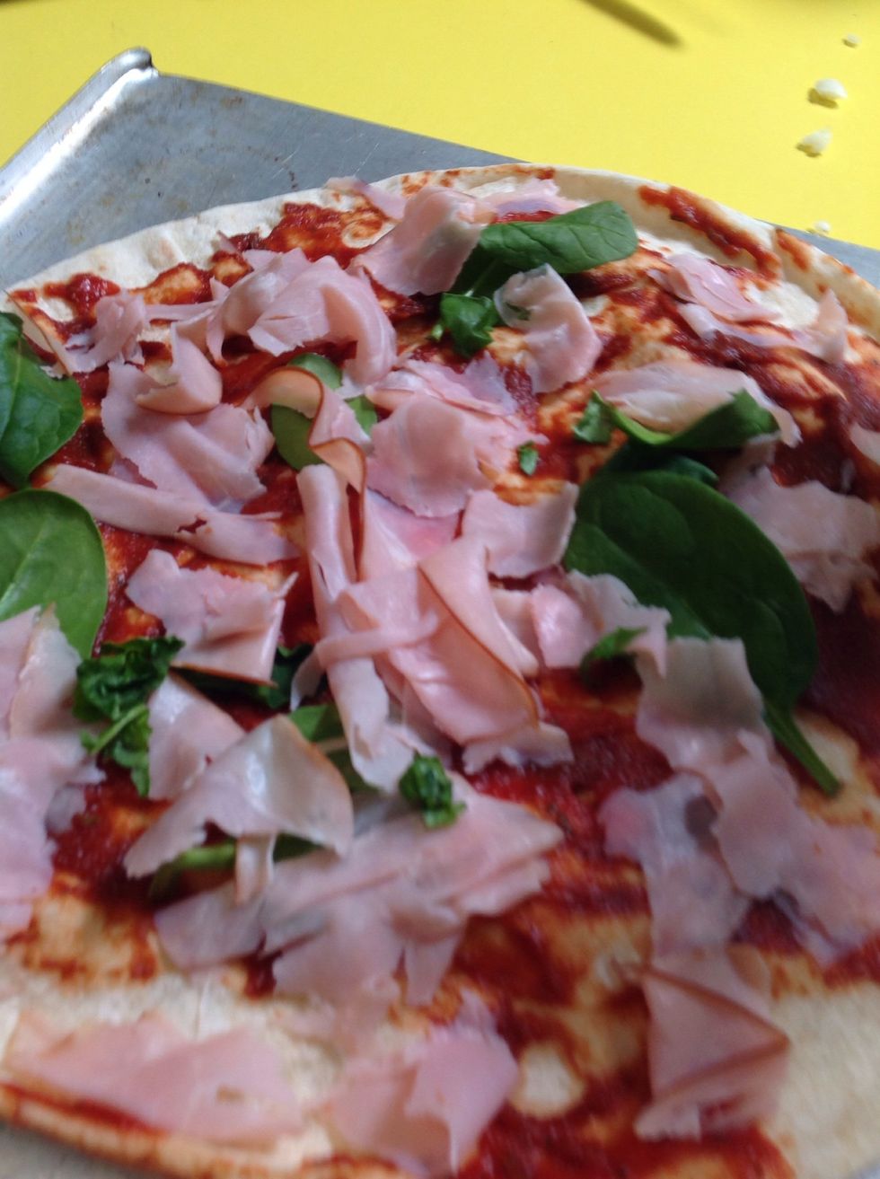 Then get some basil leaves and rip them up and sprinkle it all over the pizza