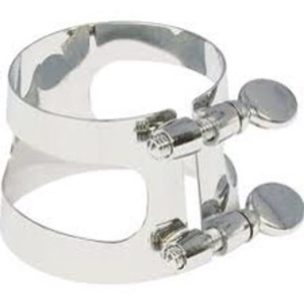 Then get the final piece that looks like this. It's called a ligature, and you want to put the mouthpiece and the reed through it then tighten the ligature.