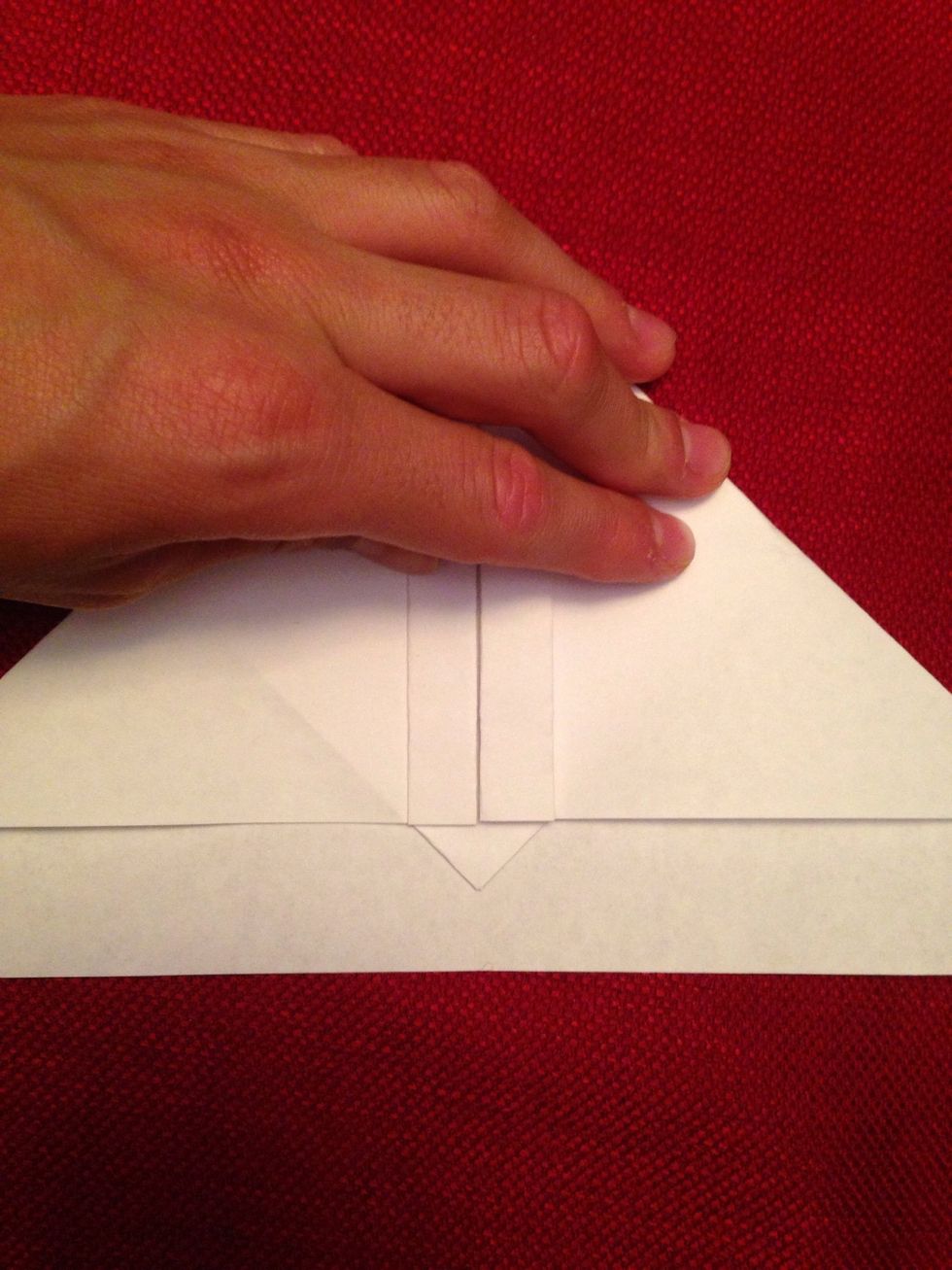 Then get the little triangle part and fold it over the two parts.