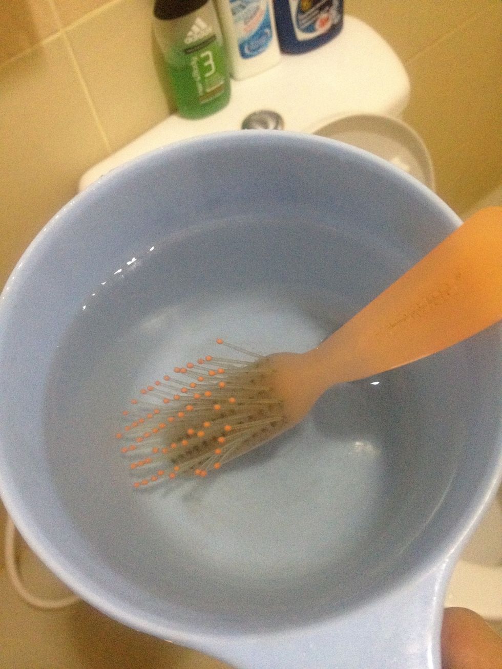 Then, get warm or hot water (I get hot instead, figured it'd *clean* it more) into the small bucket and dump your dirty hairbrush. Let it stay there for 5-10 mins.