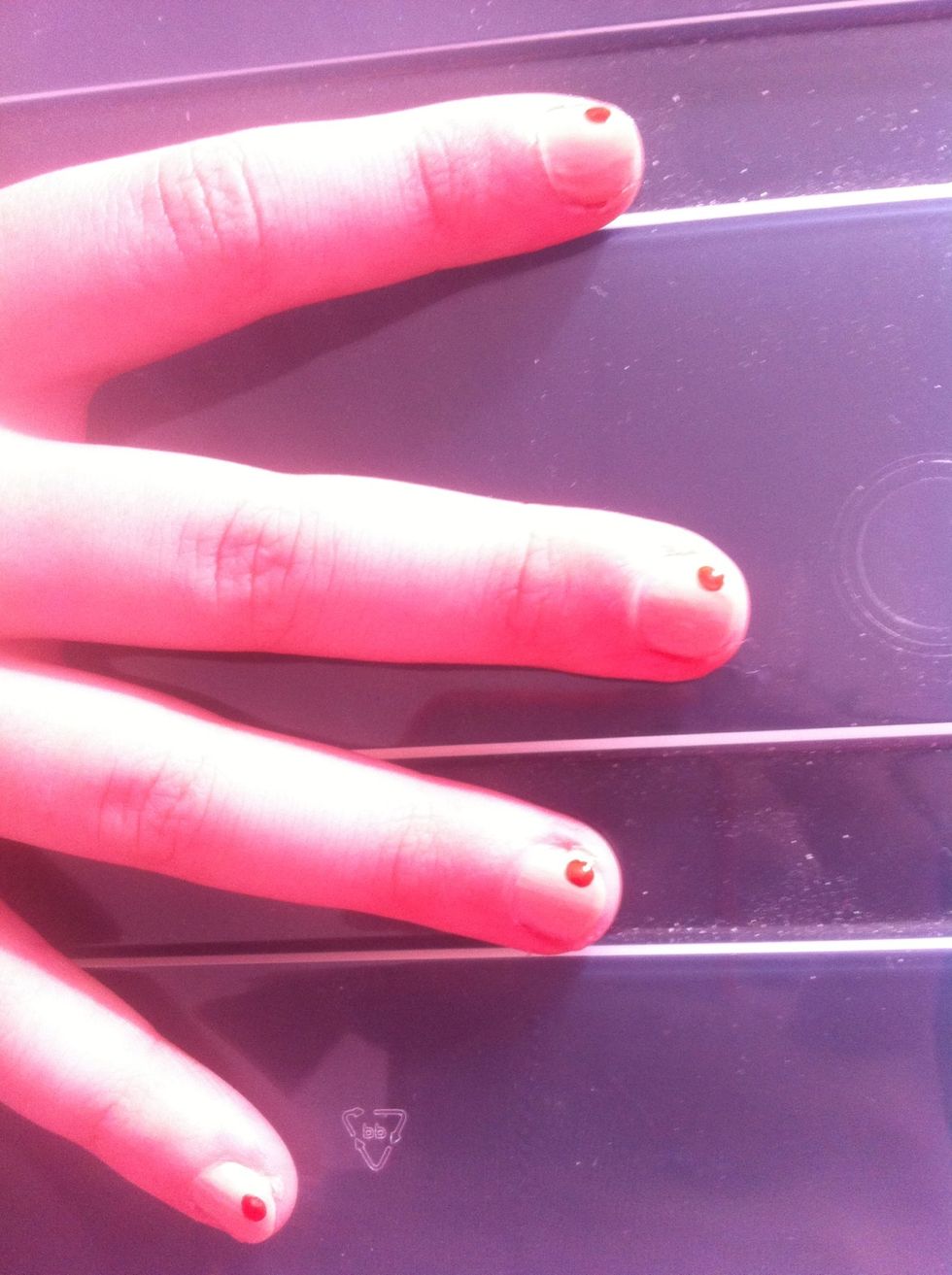 Then get your dotting tool and make a dot with one colour on your nails