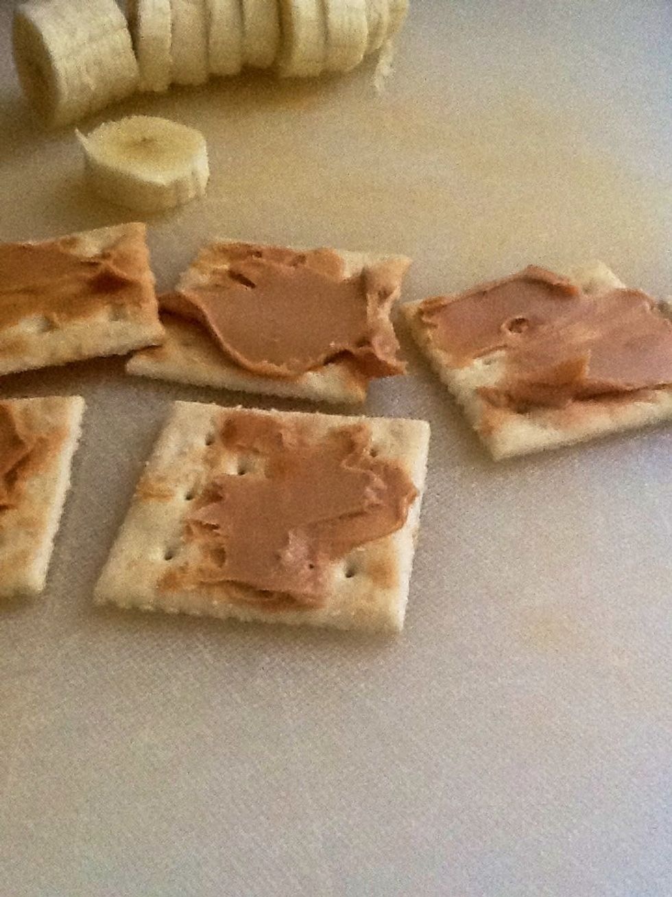 Then get your soda crackers and peanut butter and spread the peanut butter with your knife.