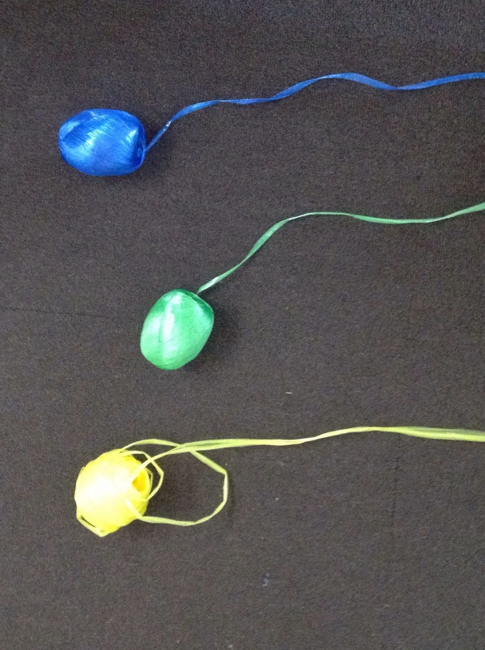 Then grab 3 coloured string ( get a friend to sit on the strings so the string doesn't go everywhere )