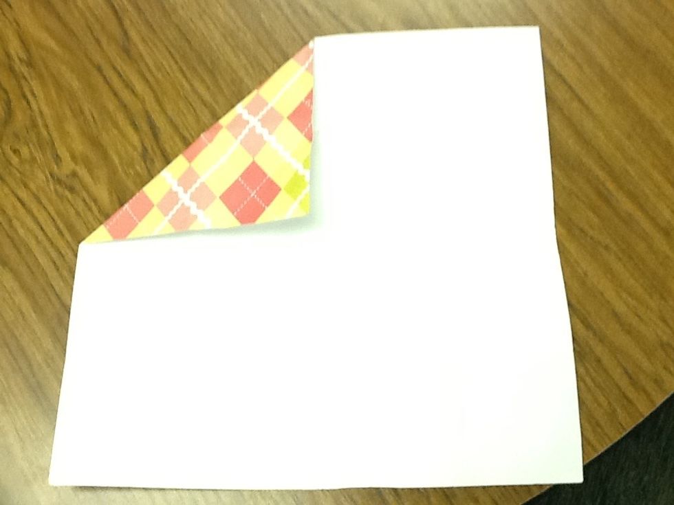 Then grab a corner and fold it to the middle.
