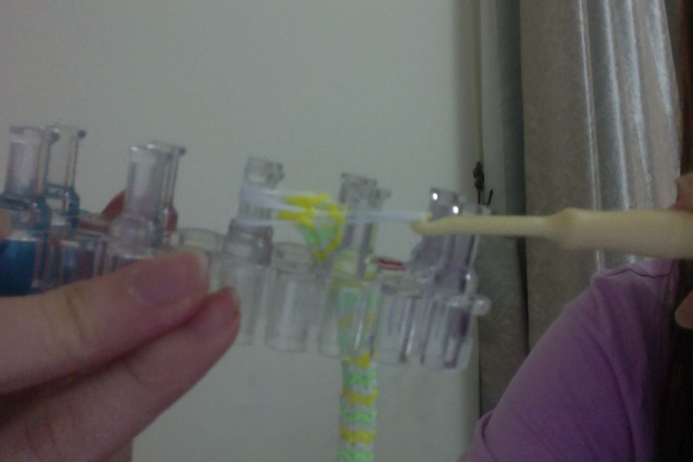 Then grab the middle peg's rubber bands,