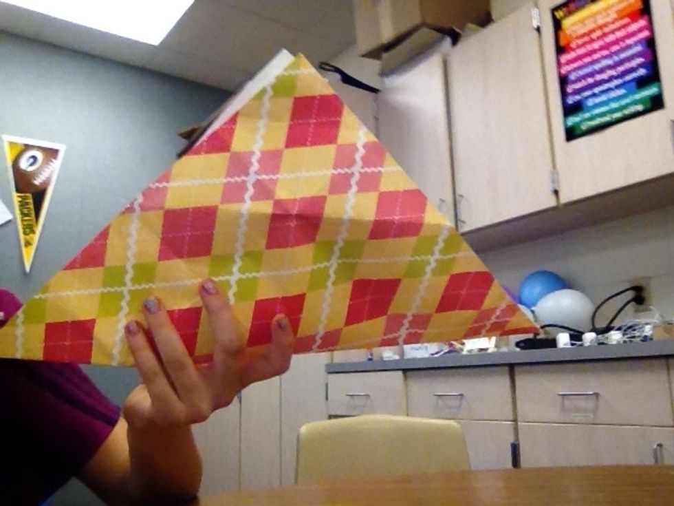 Then grab the opposite corner and fold it.