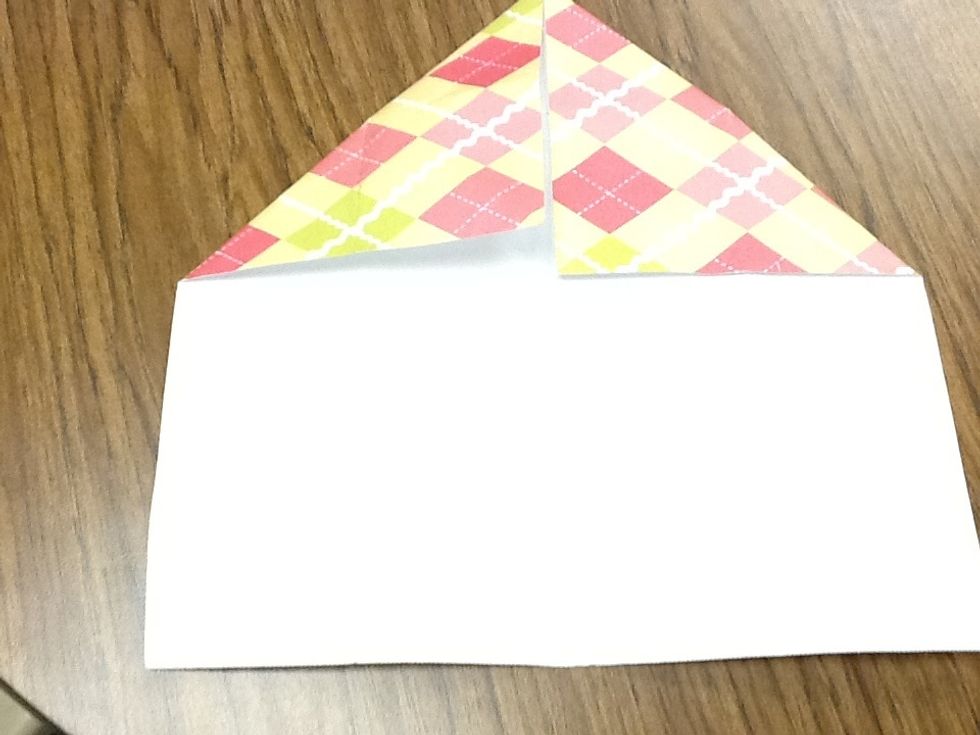 Then grab the other corner and fold it to the middle.