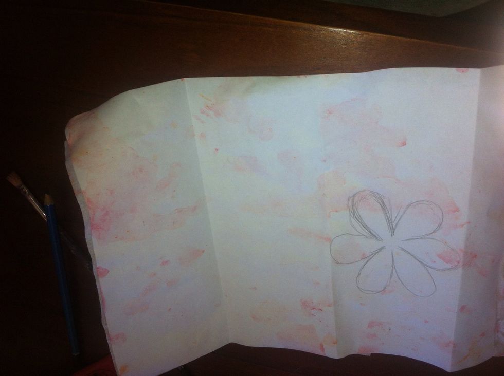 Then i flipped it around folded it into three and drew a 6 petaled flower after waiting for the paper to dry of course :)