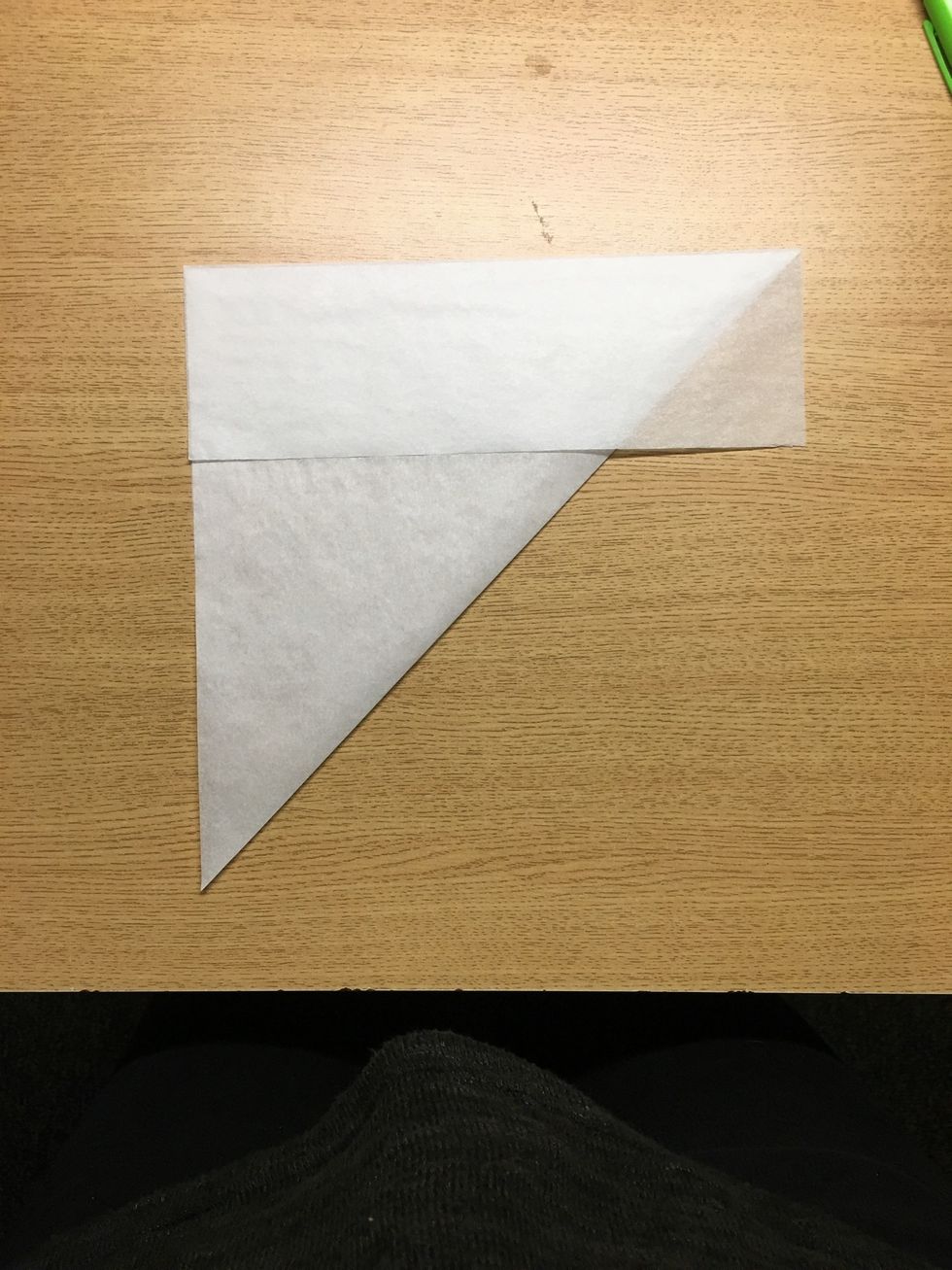 Then I fold over the excess paper on top so it is flush with the edge of the newly made square.
