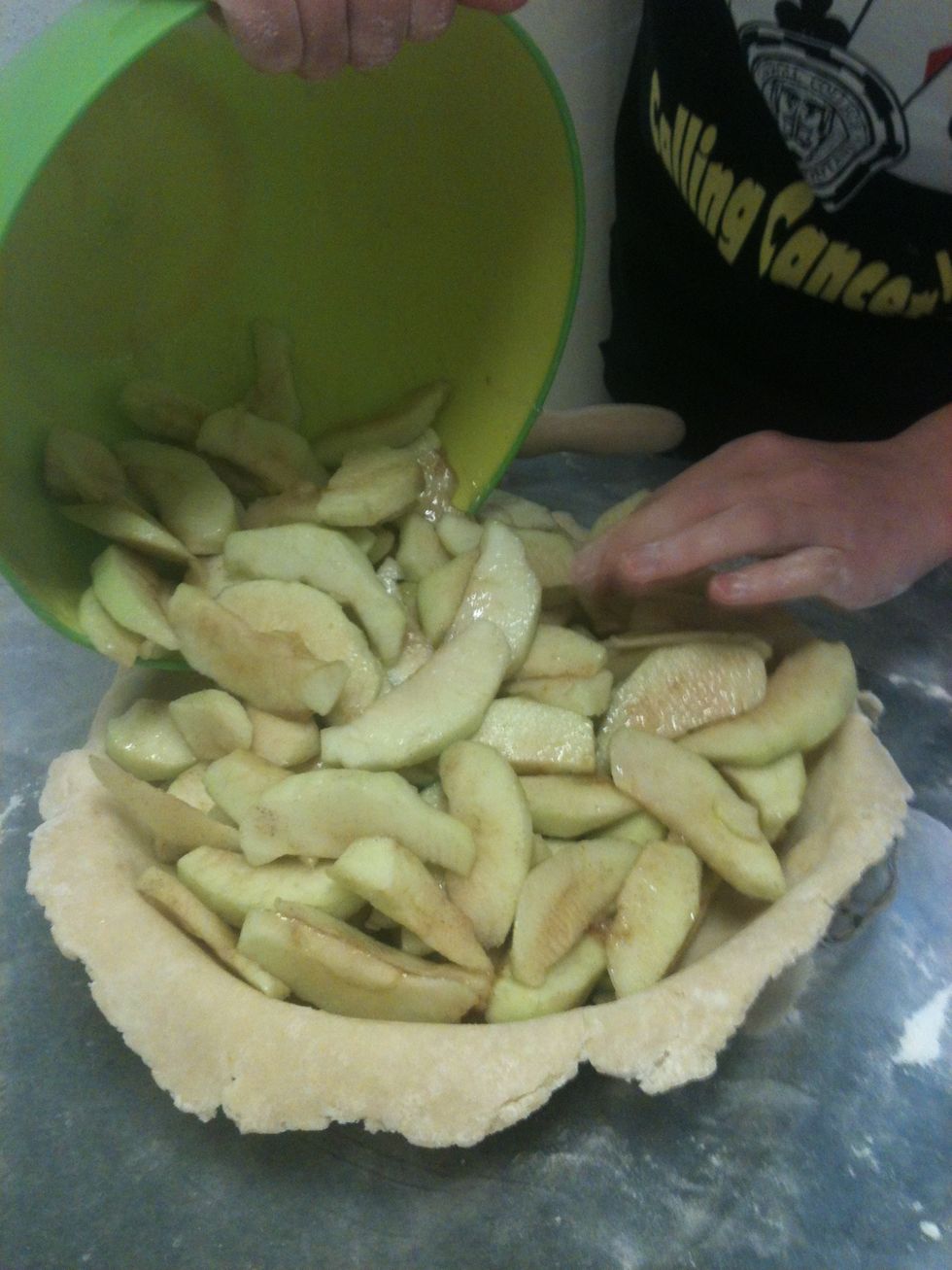 Then I pour the apples into the pie dish!