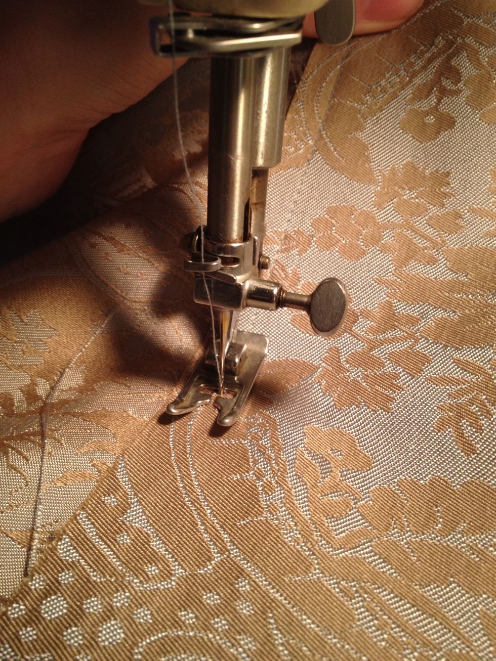 Then I sew the top 'rod pocket' a 1/2 inch in from cut. Pulling pins out as I go. I repeat this step only I sew about 2 inches from folded edge to create top 'ruffle' about rod pocket.
