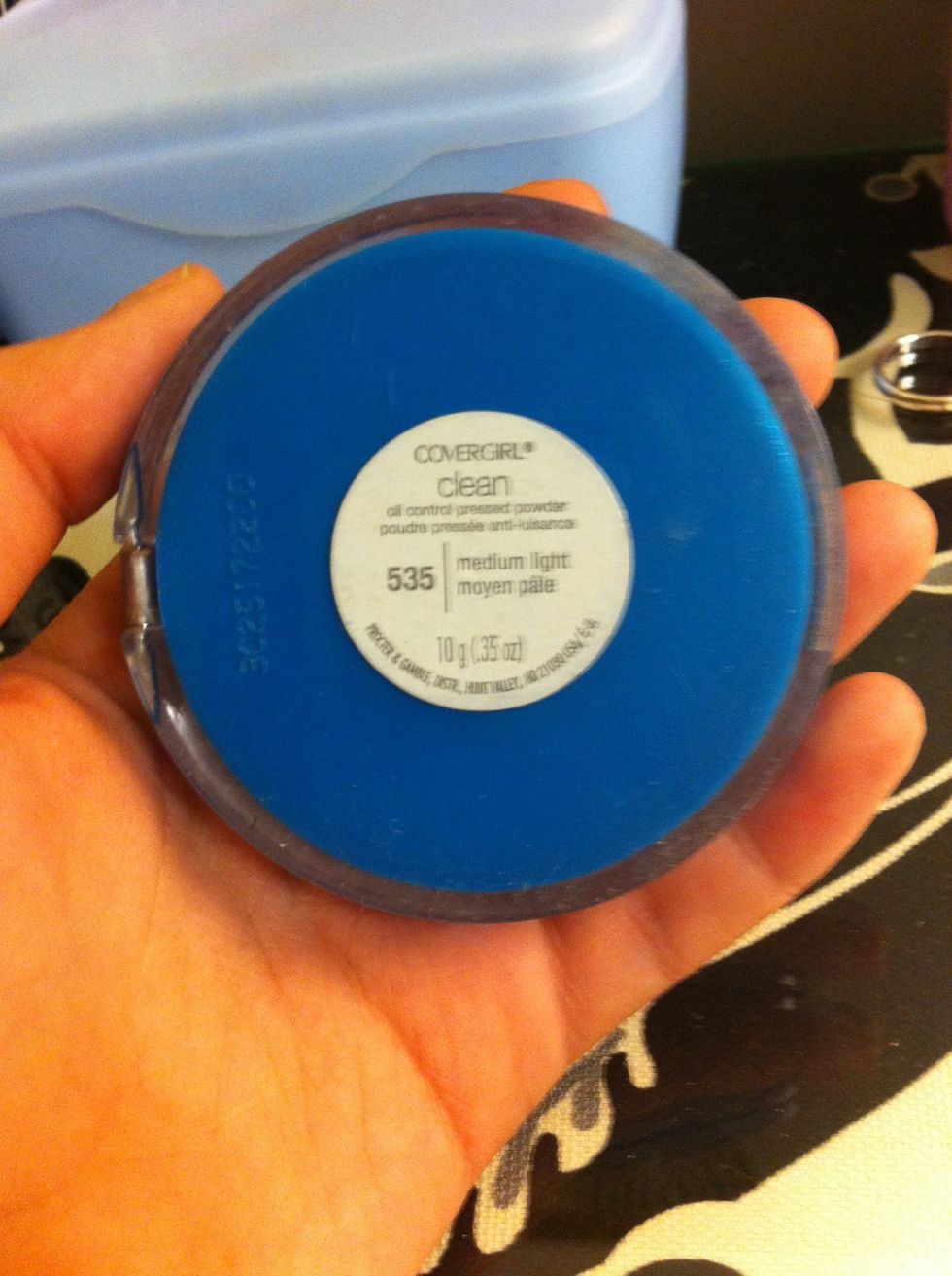 Then I take my Covergirl pressed powder in medium light. I first take and put it over my concealer, and then over my whole face.